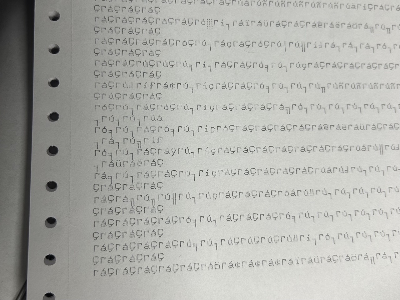 Picture of a printed sheet showing a bunch of wrongly-encoded characters